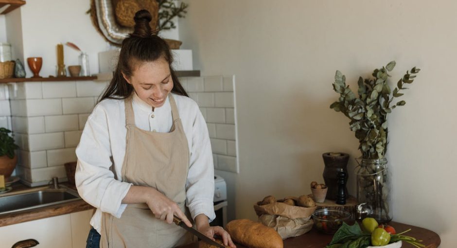 woman-wearing-apron-slicing-bread